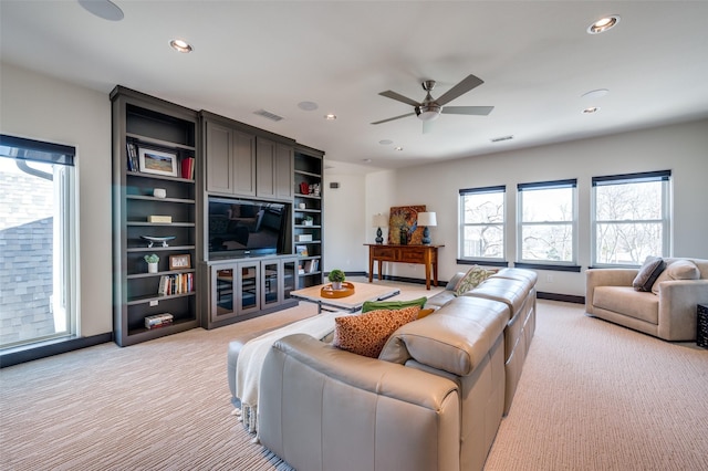 living room with ceiling fan and light carpet