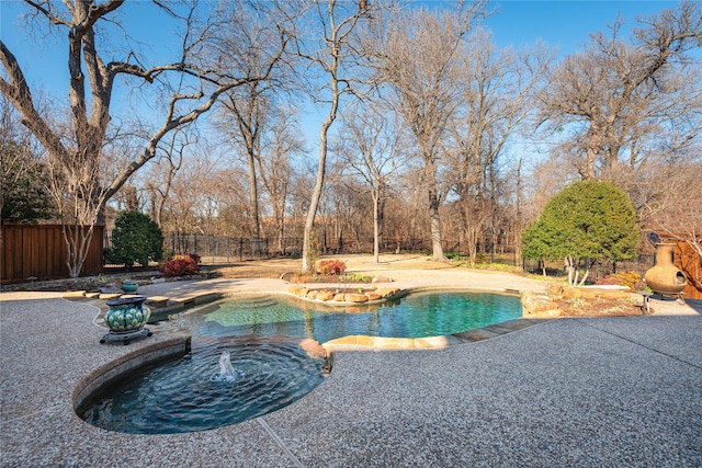 view of swimming pool featuring a fenced in pool, a patio area, a fenced backyard, and a jacuzzi