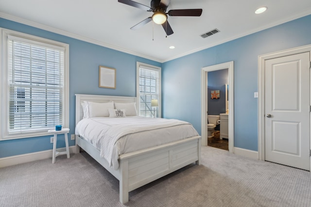 bedroom featuring light carpet, ceiling fan, ensuite bath, and crown molding