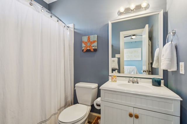 bathroom featuring curtained shower, vanity, and toilet