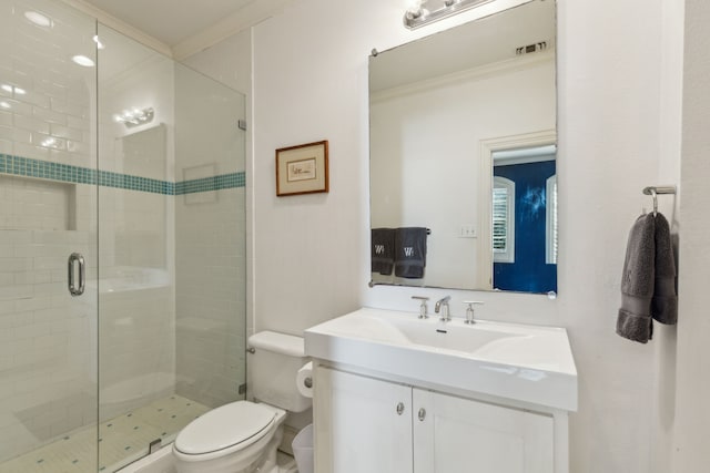 bathroom featuring crown molding, vanity, toilet, and a shower with door