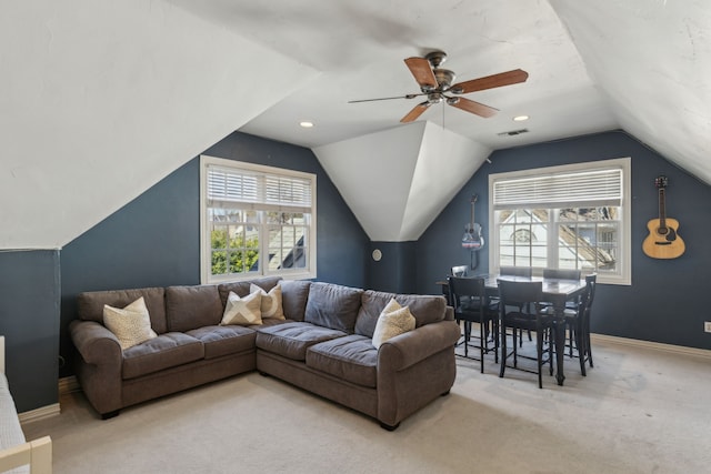 carpeted living room with plenty of natural light and lofted ceiling