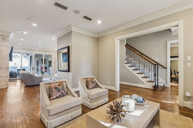 living room featuring hardwood / wood-style floors and crown molding