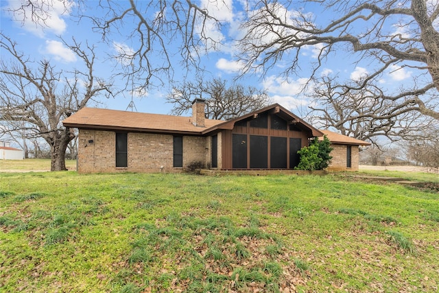 rear view of house with a lawn