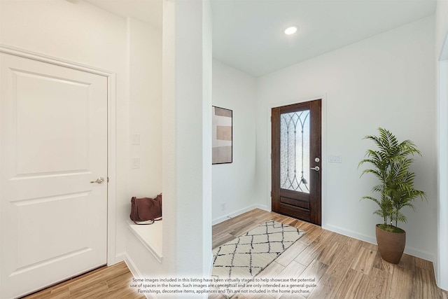 entryway with hardwood / wood-style flooring