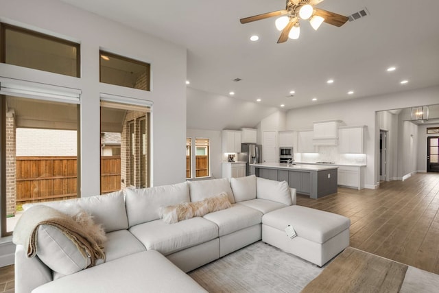 living room with light wood-type flooring and ceiling fan