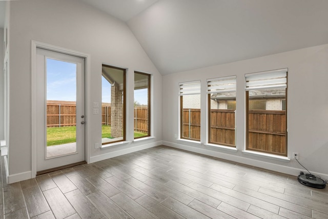 5716 Turner May Dr, Fort Worth, TX 76126 - unfurnished sunroom with healthy amount of natural light, wood finished floors, vaulted ceiling, and baseboards