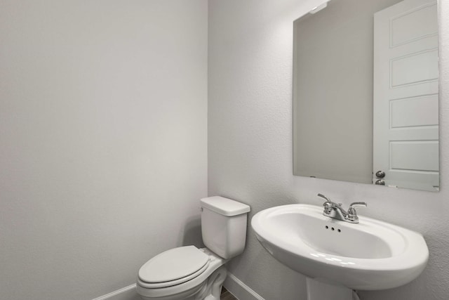 5716 Turner May Dr, Fort Worth, TX 76126 - bathroom featuring a sink, toilet, and baseboards