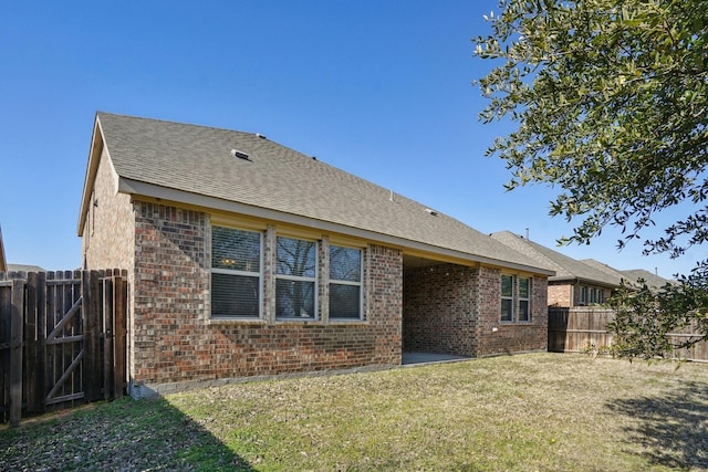 rear view of house featuring a lawn