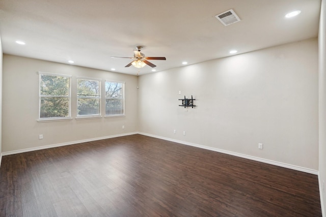 unfurnished room with dark wood-type flooring and ceiling fan