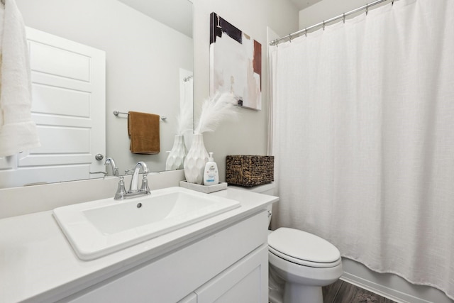 full bathroom featuring shower / tub combo with curtain, wood-type flooring, vanity, and toilet