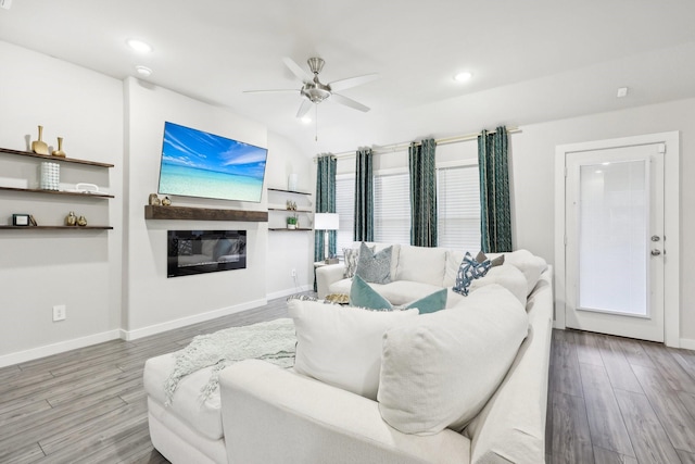 living room featuring hardwood / wood-style floors and ceiling fan