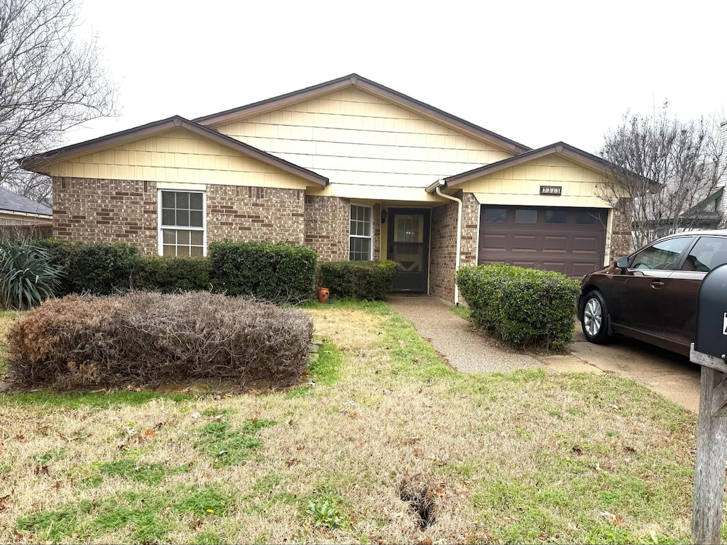 single story home with a front lawn and a garage