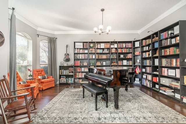 living area featuring ornamental molding, wood finished floors, and an inviting chandelier