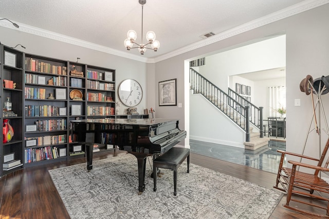 home office with baseboards, ornamental molding, wood finished floors, a textured ceiling, and a chandelier