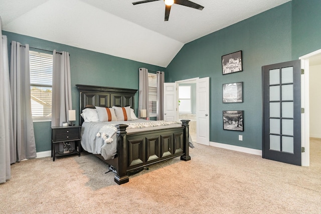 bedroom featuring a ceiling fan, light colored carpet, vaulted ceiling, and baseboards