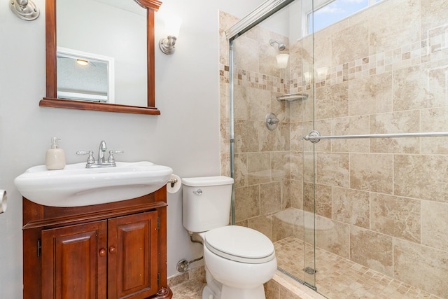 full bath featuring a stall shower, vanity, and toilet