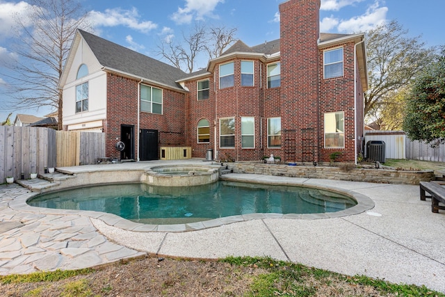 view of swimming pool with a patio, central AC, a fenced backyard, and a pool with connected hot tub