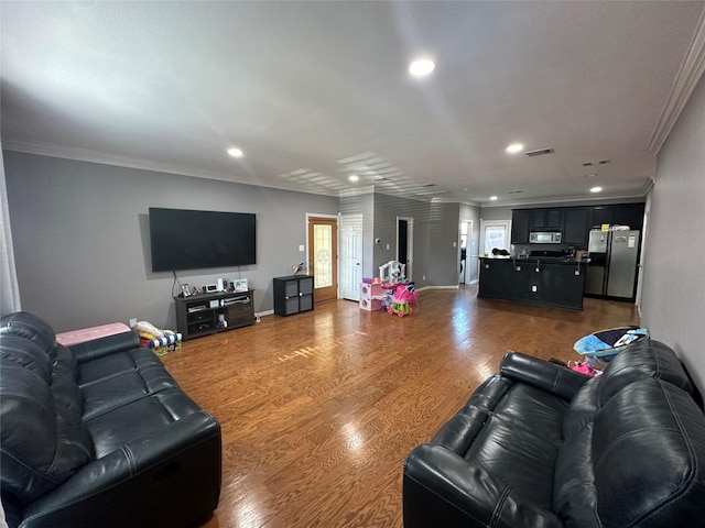 living room with ornamental molding, hardwood / wood-style flooring, and plenty of natural light