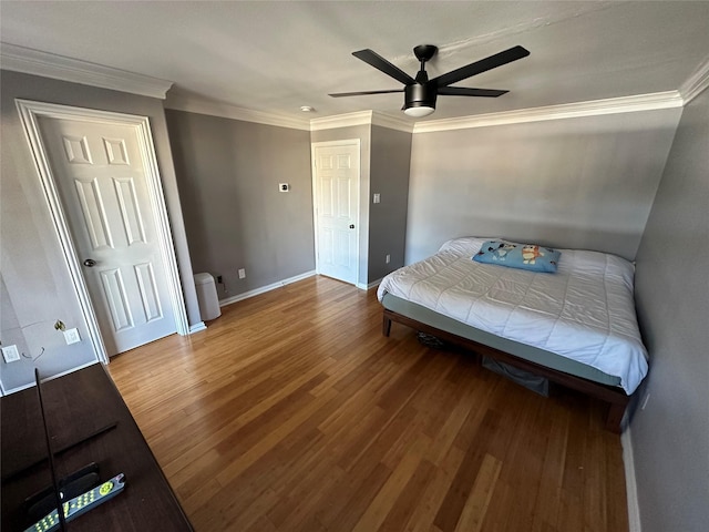 bedroom featuring hardwood / wood-style flooring, ornamental molding, and ceiling fan