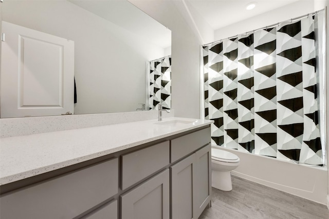 full bathroom featuring shower / bathtub combination with curtain, wood-type flooring, vanity, and toilet