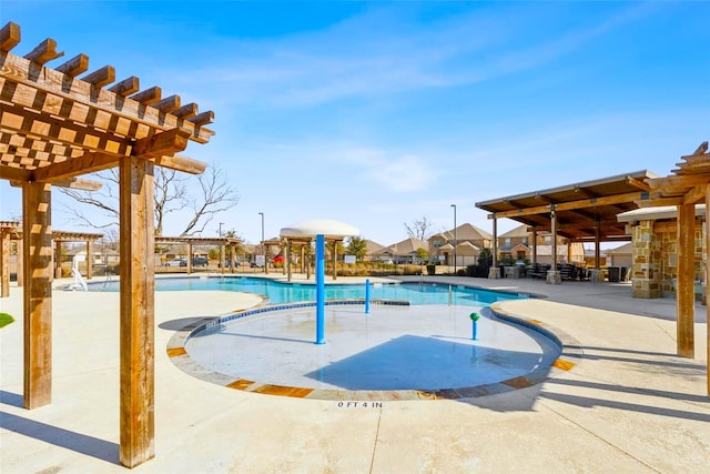 community pool with a patio area and a pergola