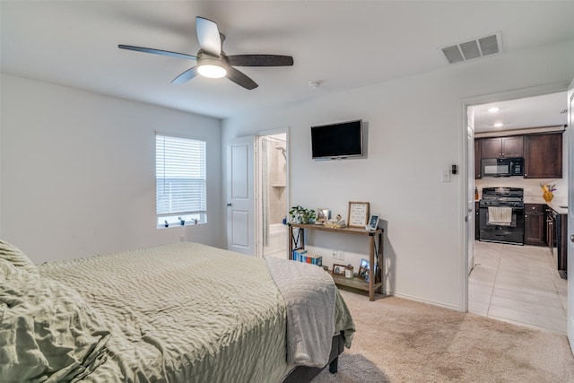 bedroom with light tile patterned flooring, light colored carpet, a ceiling fan, visible vents, and ensuite bath