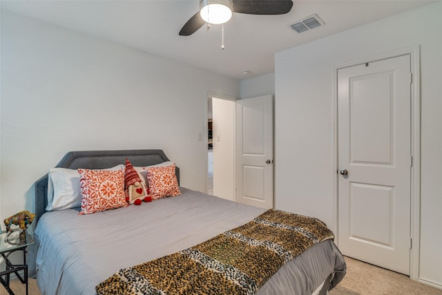 bedroom with light carpet, ceiling fan, and visible vents