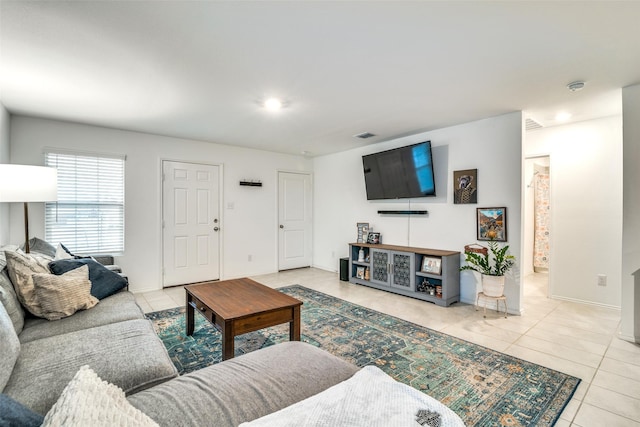 living room with light tile patterned floors and baseboards