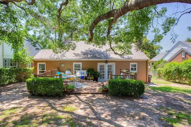 rear view of house featuring french doors and a wooden deck