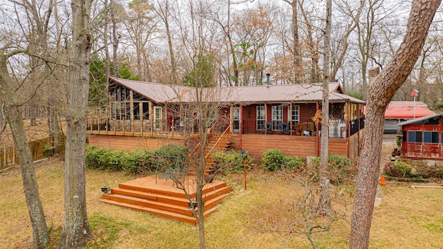 view of front of house with a deck and a front yard