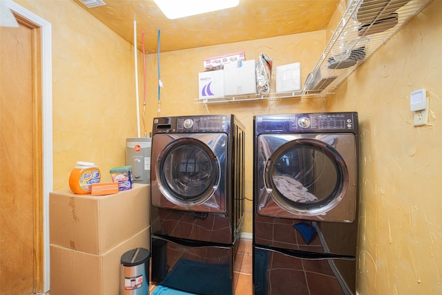 laundry area with washer and dryer and tile patterned flooring