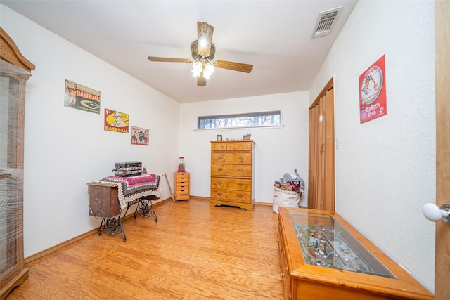 office with ceiling fan and light hardwood / wood-style floors