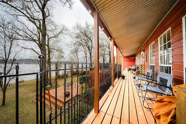 wooden terrace featuring a water view