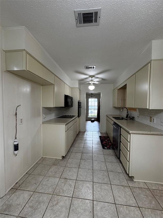 kitchen with sink, backsplash, cream cabinetry, ceiling fan, and black appliances