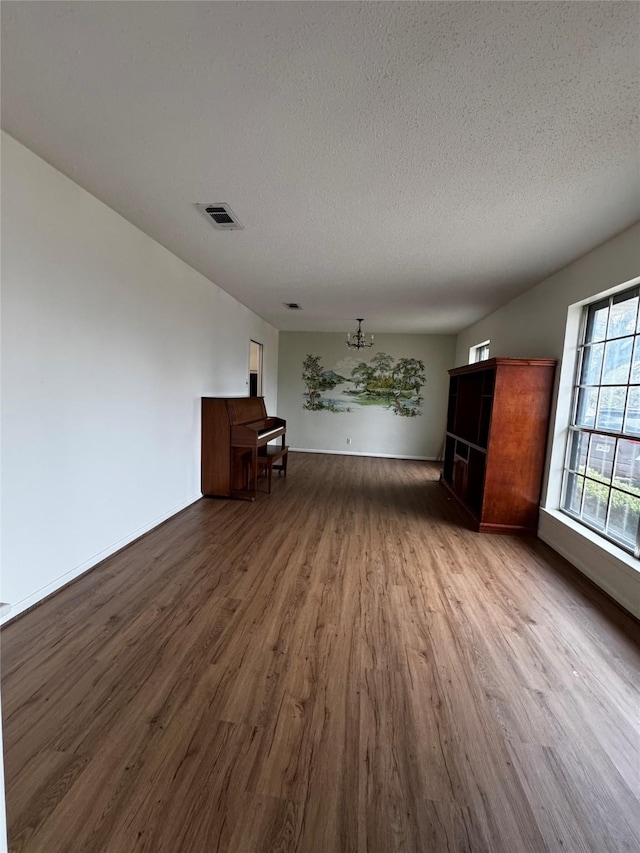 interior space with wood-type flooring and a textured ceiling