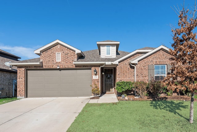 view of front of property with a garage and a front yard