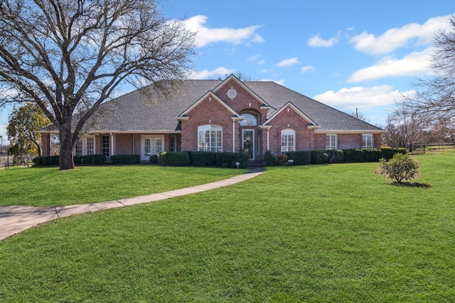 ranch-style house featuring french doors and a front lawn