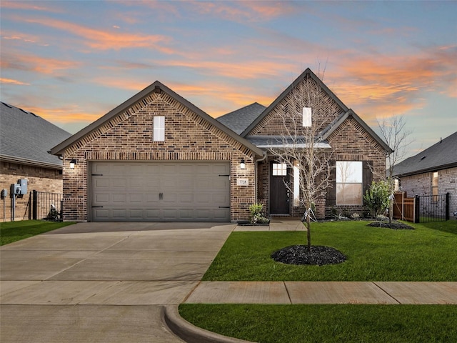 view of front of property featuring brick siding, fence, concrete driveway, a front yard, and an attached garage