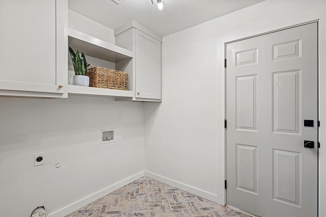 clothes washing area with cabinet space, baseboards, hookup for a washing machine, brick floor, and hookup for an electric dryer