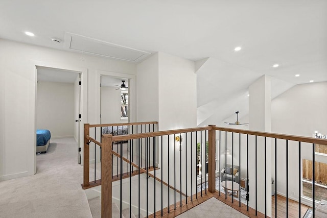 hall featuring recessed lighting, attic access, light colored carpet, and an upstairs landing