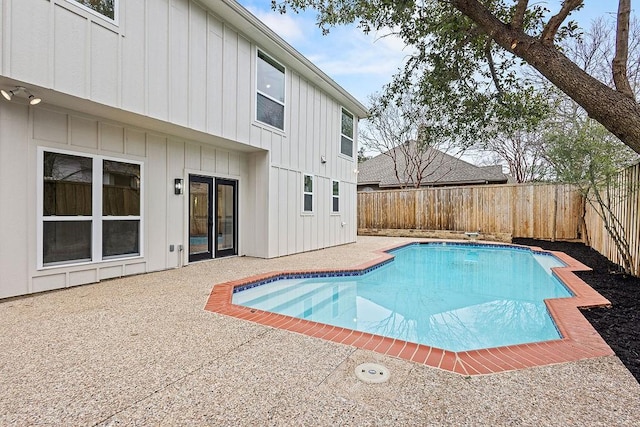 view of swimming pool featuring a fenced in pool, a fenced backyard, and a patio