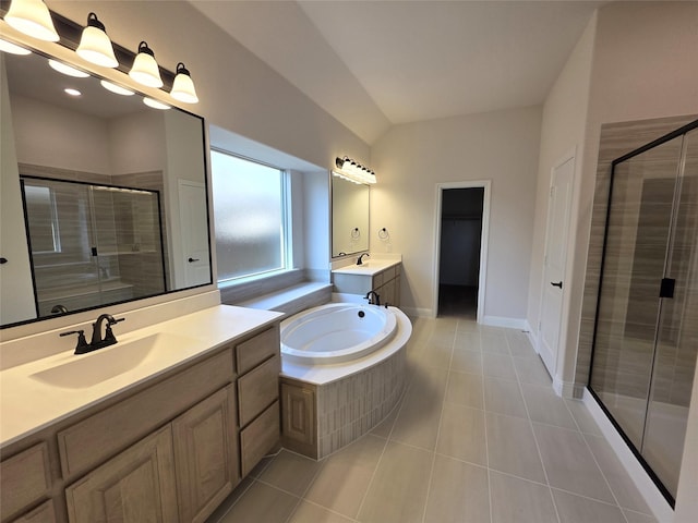 bathroom featuring a shower stall, lofted ceiling, tile patterned floors, and a sink