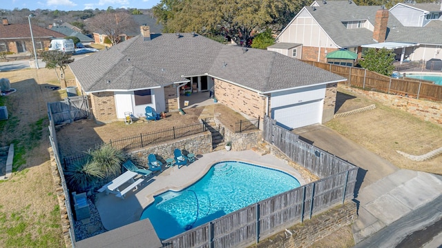 view of swimming pool featuring a fenced in pool, a residential view, a patio area, and a fenced backyard