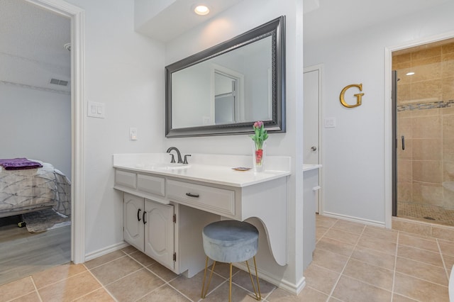 full bathroom with tile patterned flooring, visible vents, vanity, baseboards, and a stall shower