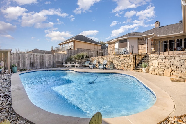 view of swimming pool with a patio area, a fenced backyard, and a fenced in pool