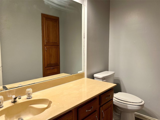 half bathroom with vanity and toilet