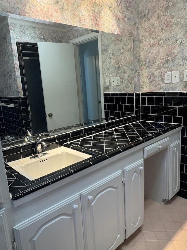 kitchen with tile walls, light tile patterned floors, and white cabinets