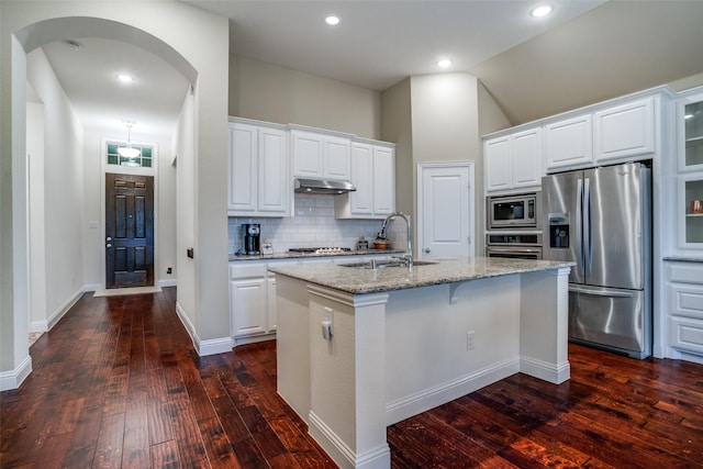 kitchen featuring an island with sink, white cabinetry, stainless steel appliances, and a sink