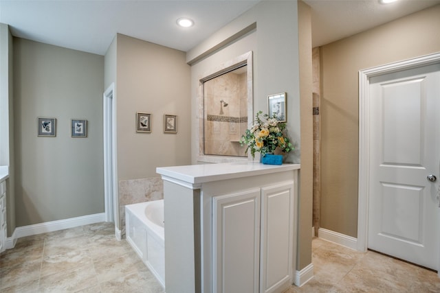 full bath featuring baseboards, tile patterned floors, a tile shower, vanity, and a bath